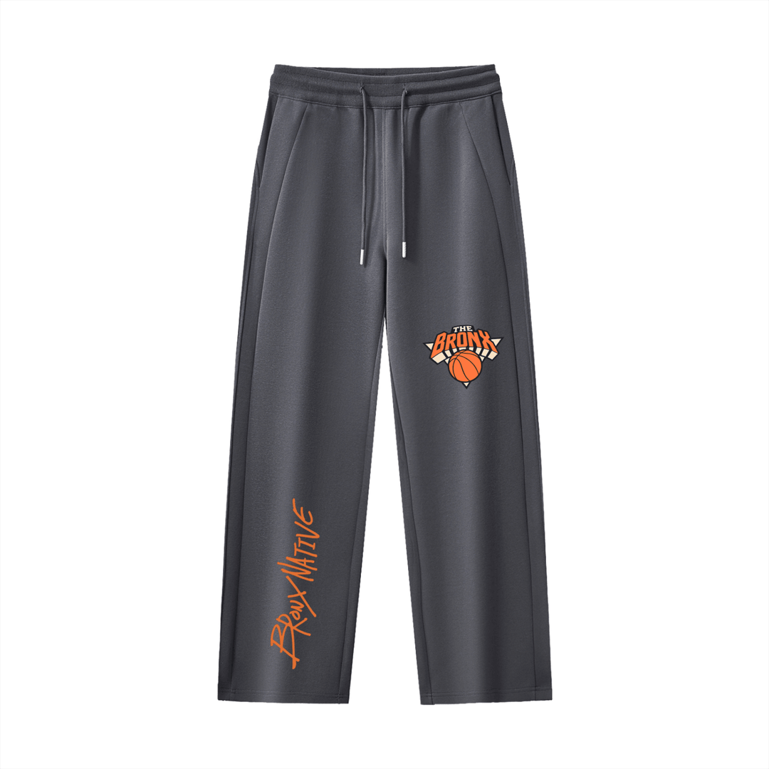 Dark gray Bronx Native sweatpants with orange 'The Bronx' basketball graphic and side script logo