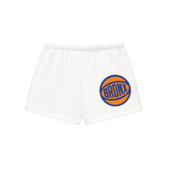 White Bronx streetwear shorts with orange and blue basketball logo, NYC-inspired athletic wear