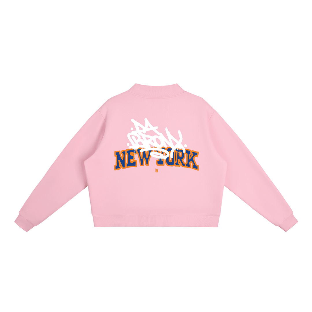 Pink cropped hoodie with Bronx New York graffiti graphic, bold streetwear style