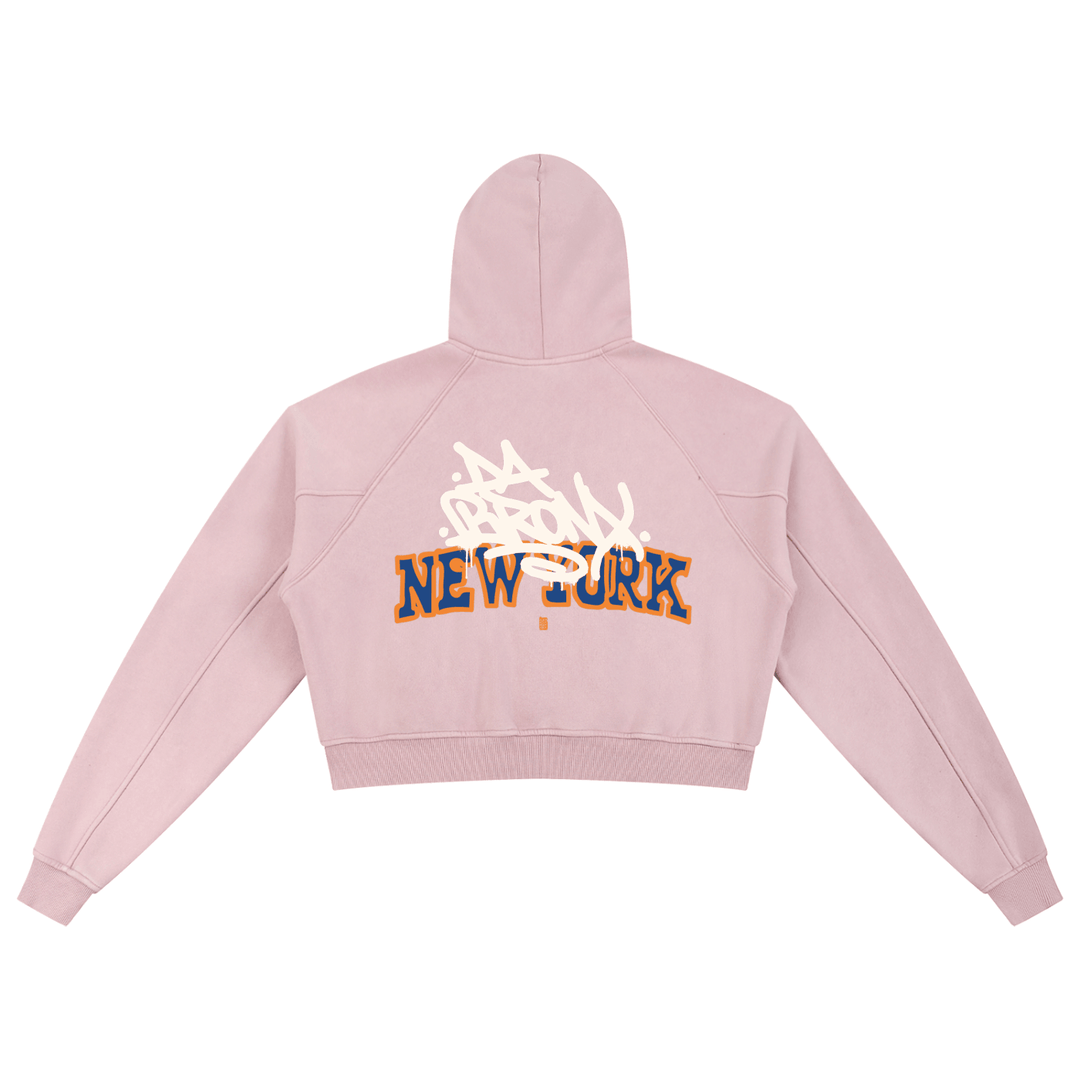 Pink cropped hoodie with 'Bronx New York' graffiti design, bold streetwear style