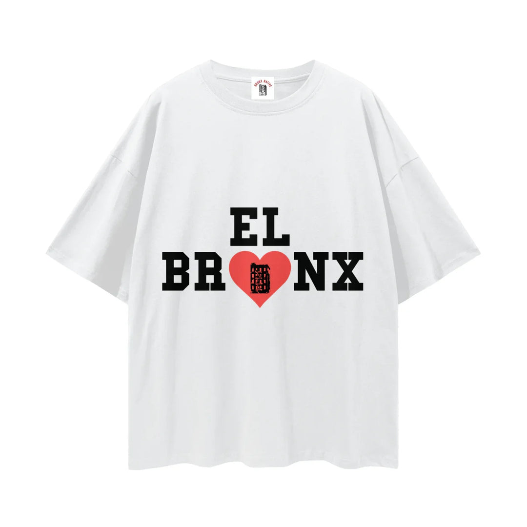 White t-shirt with bold 'El Bronx' text, red heart, and NYC building graphic on chest.