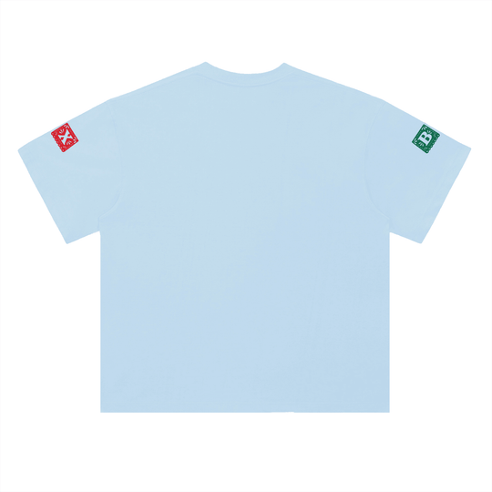 Light blue t-shirt with red and green sleeve patches, NYC streetwear style