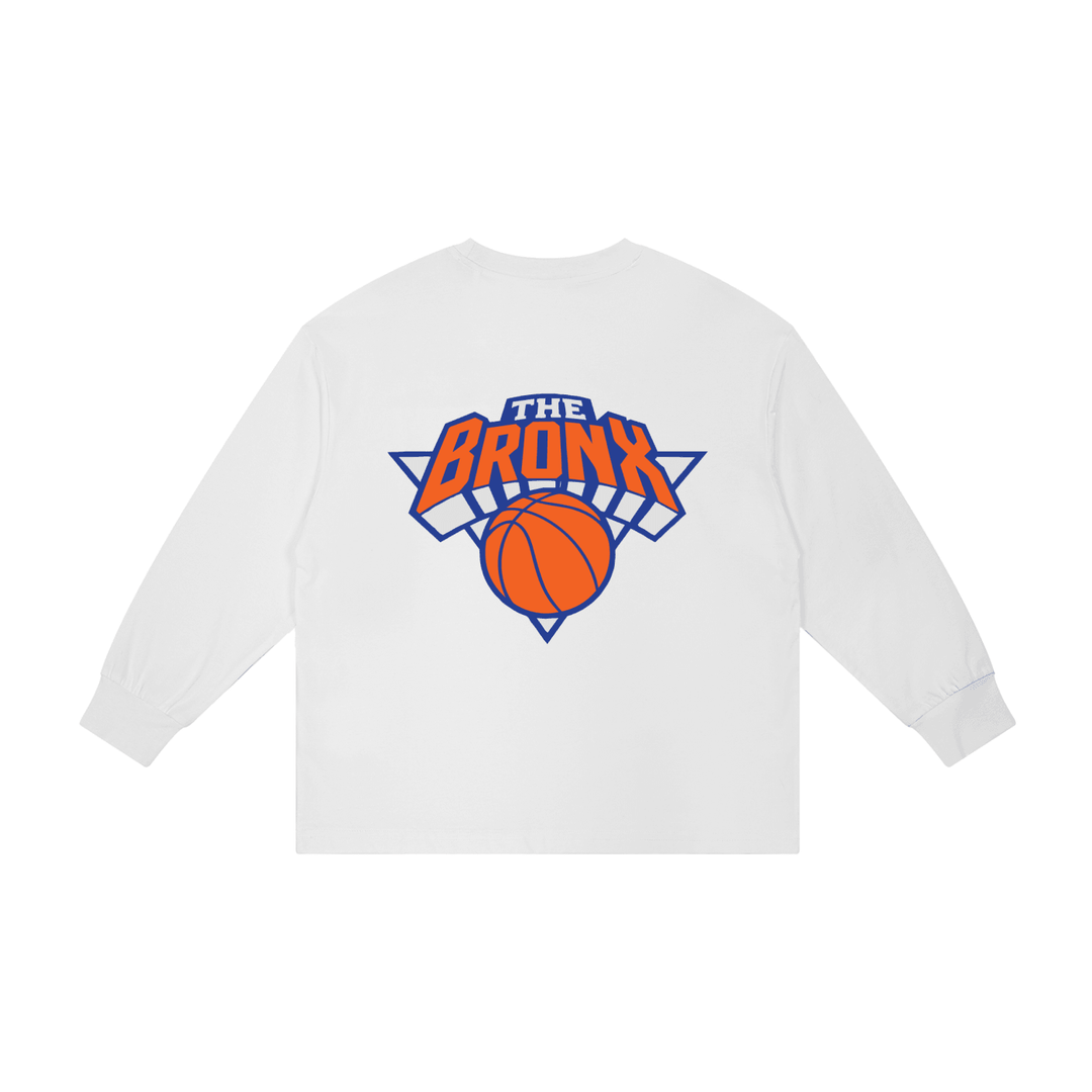 White long sleeve tee with 'The Bronx' basketball graphic, bold streetwear design inspired by NYC culture