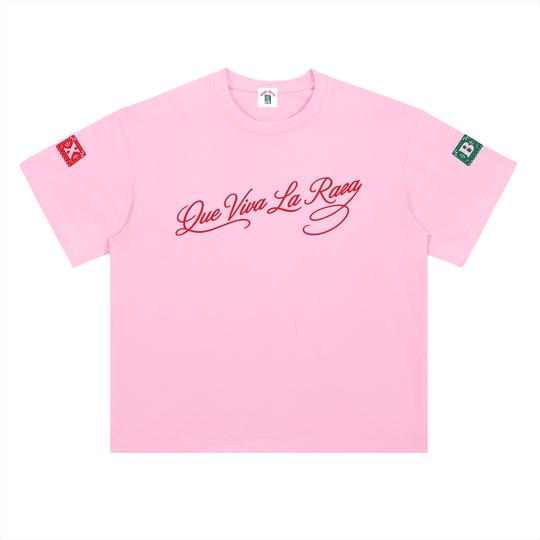 Pink 'Que Viva La Raza' streetwear tee with red script and sleeve patches, NYC-inspired bold fashion.