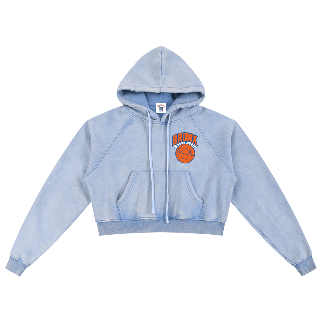 Light blue cropped hoodie with Bronx basketball graphic, streetwear style