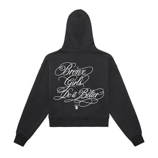 Black hoodie with 'Bronx Girls Do It Better' in white script, NYC-inspired streetwear design.