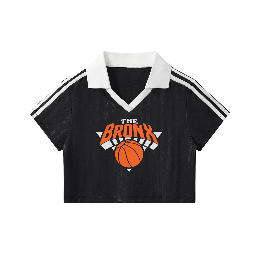 Black cropped polo shirt with 'The Bronx' basketball graphic, white collar, and striped sleeves