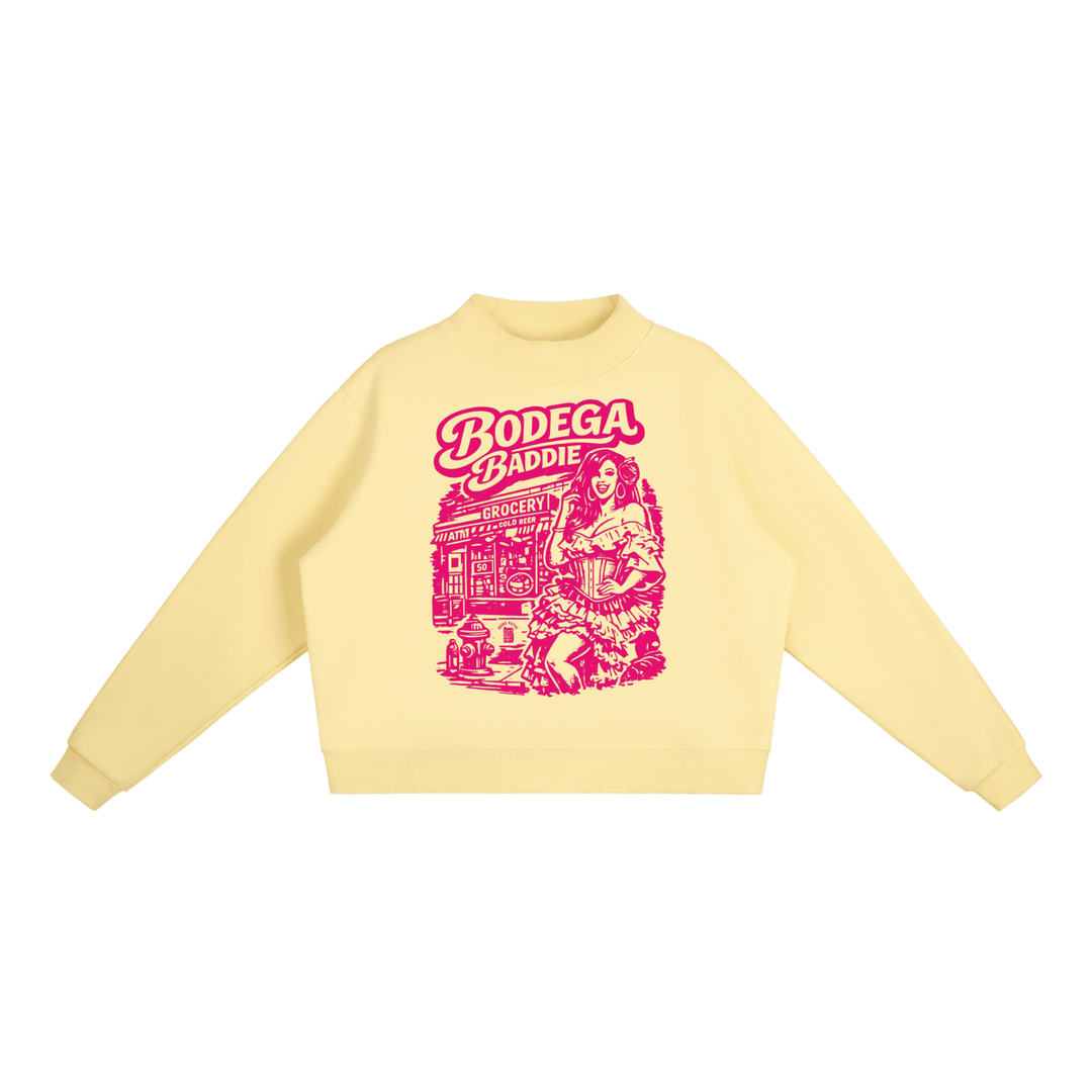 Yellow hoodie with pink 'Bodega Baddie' graphic, NYC streetwear style