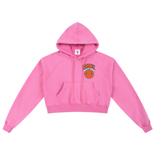 Pink cropped hoodie with Bronx basketball graphic, NYC streetwear style