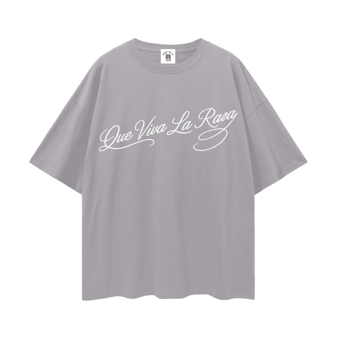 Gray oversized tee with 'Que Viva La Raza' script, bold streetwear inspired by NYC culture