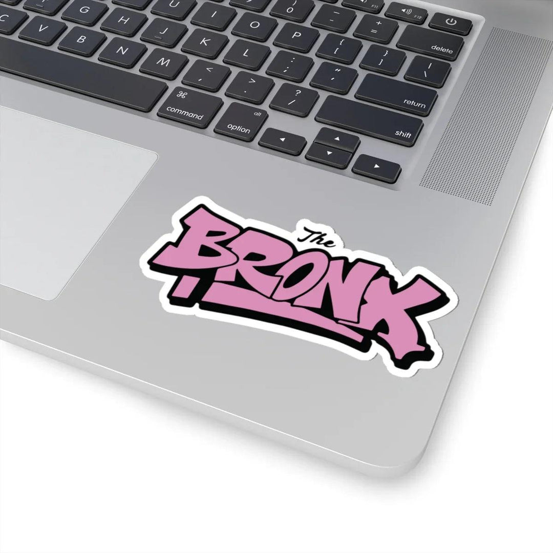 Pink 'The Bronx' graffiti sticker on laptop, NYC streetwear style