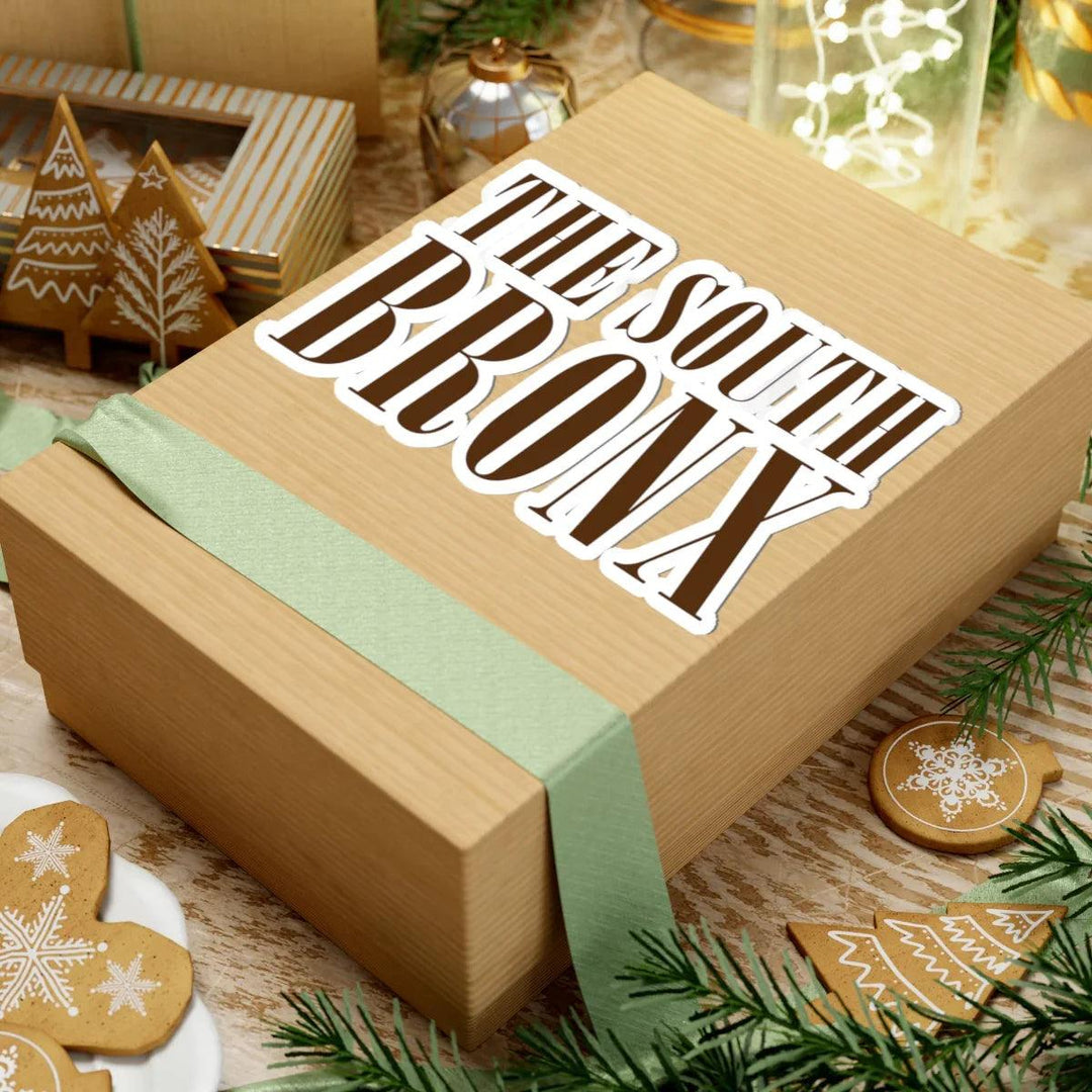 The South Bronx gift box with festive gingerbread decor and green ribbon, perfect for holiday gifting.