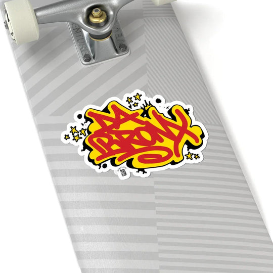 Vibrant Bronx graffiti sticker on skateboard deck, bold streetwear style with stars and urban flair.