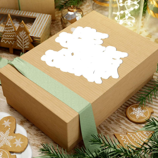 Festive gift box with snowflake cutout, green ribbon, and holiday cookies, perfect for Christmas gifting.