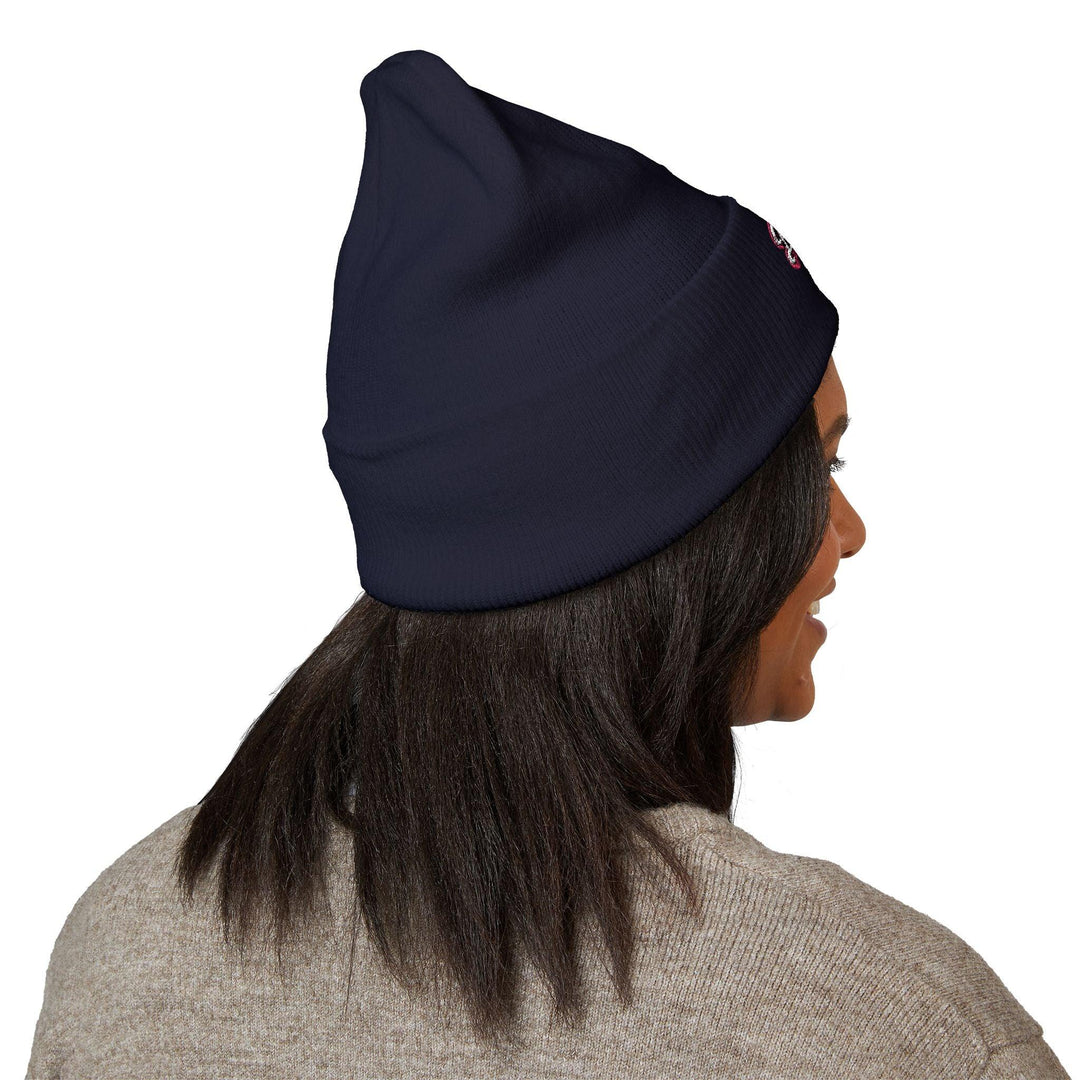 Navy blue beanie with small embroidered logo, worn by woman in cozy sweater, NYC streetwear style
