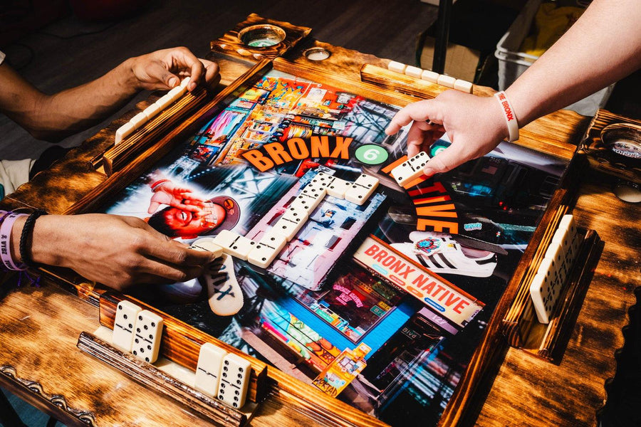 Close-up of a board game with colorful graphics and text on a wooden table.