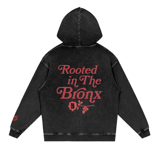 Black hoodie with 'Rooted in The Bronx' text on the back against a white background