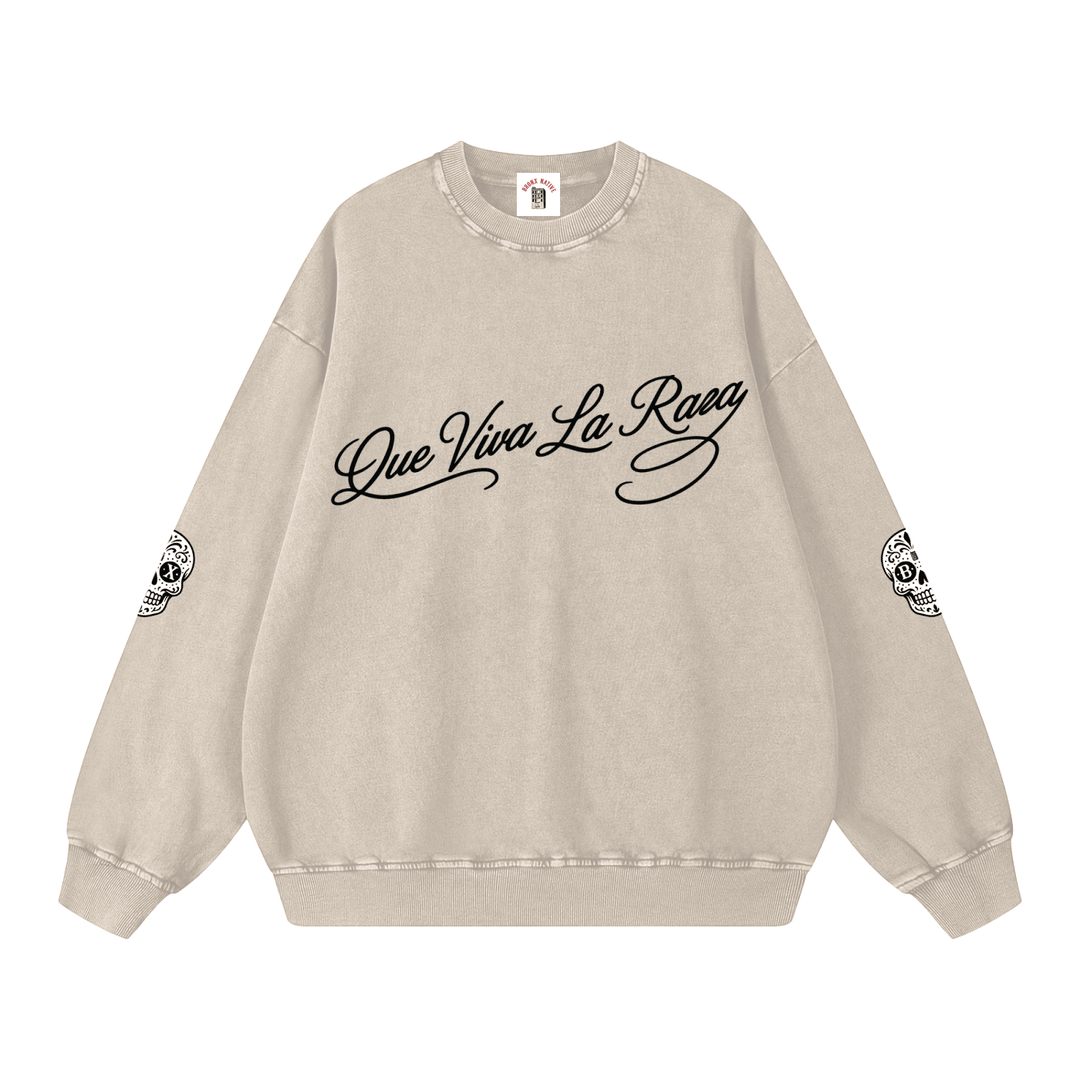 Beige sweatshirt with 'Que Viva La Raza' text and graphic designs on a white background