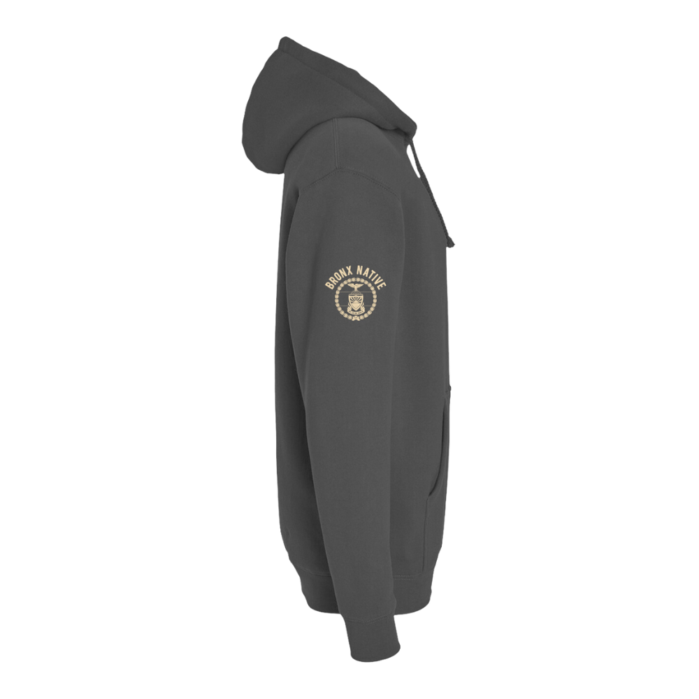 Side view of dark gray hoodie with Bronx Native emblem on sleeve, featuring front pockets and drawstring hood