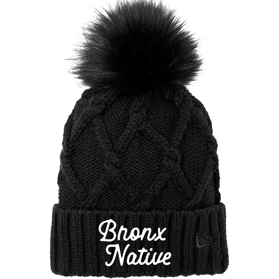 Black knit beanie with pom-pom and 'Bronx Native' text on a white background