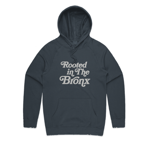 Navy hoodie with 'Rooted in The Bronx' text on a white background
