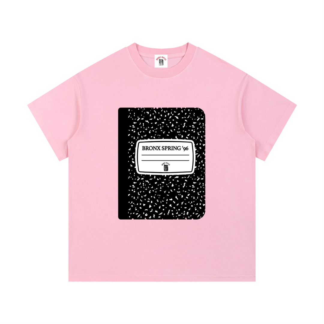 Pink t-shirt with a black and white graphic design on a white background