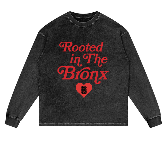 Black long-sleeve shirt with red text 'Rooted in The Bronx' on a white background
