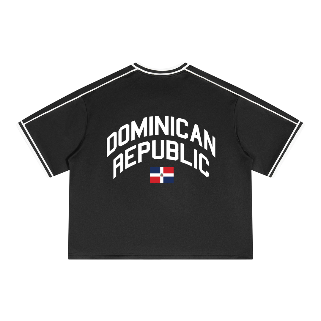 A black short-sleeve t-shirt with white athletic-style shoulder stripes and a white arched 'DOMINICAN REPUBLIC' text graphic on the chest, featuring a small Dominican Republic flag underneath, shown on a plain white background.